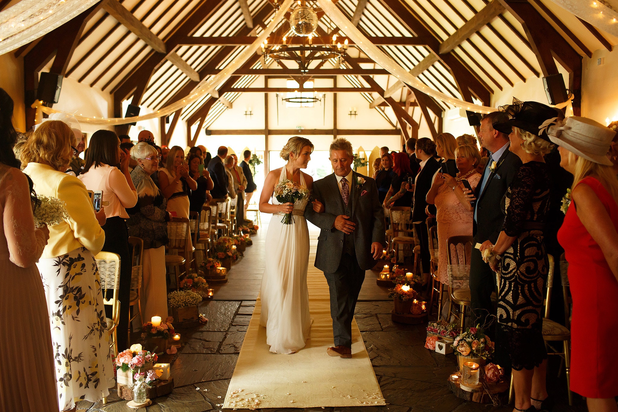 Bride being walked down the white carpet aisle by her father - great hall at mains wedding photography