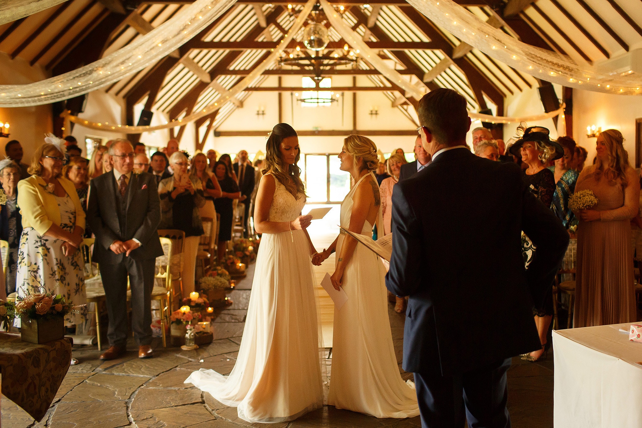 Wide photograph of the ceremony room at the Great Hall at Mains facing all the guests 