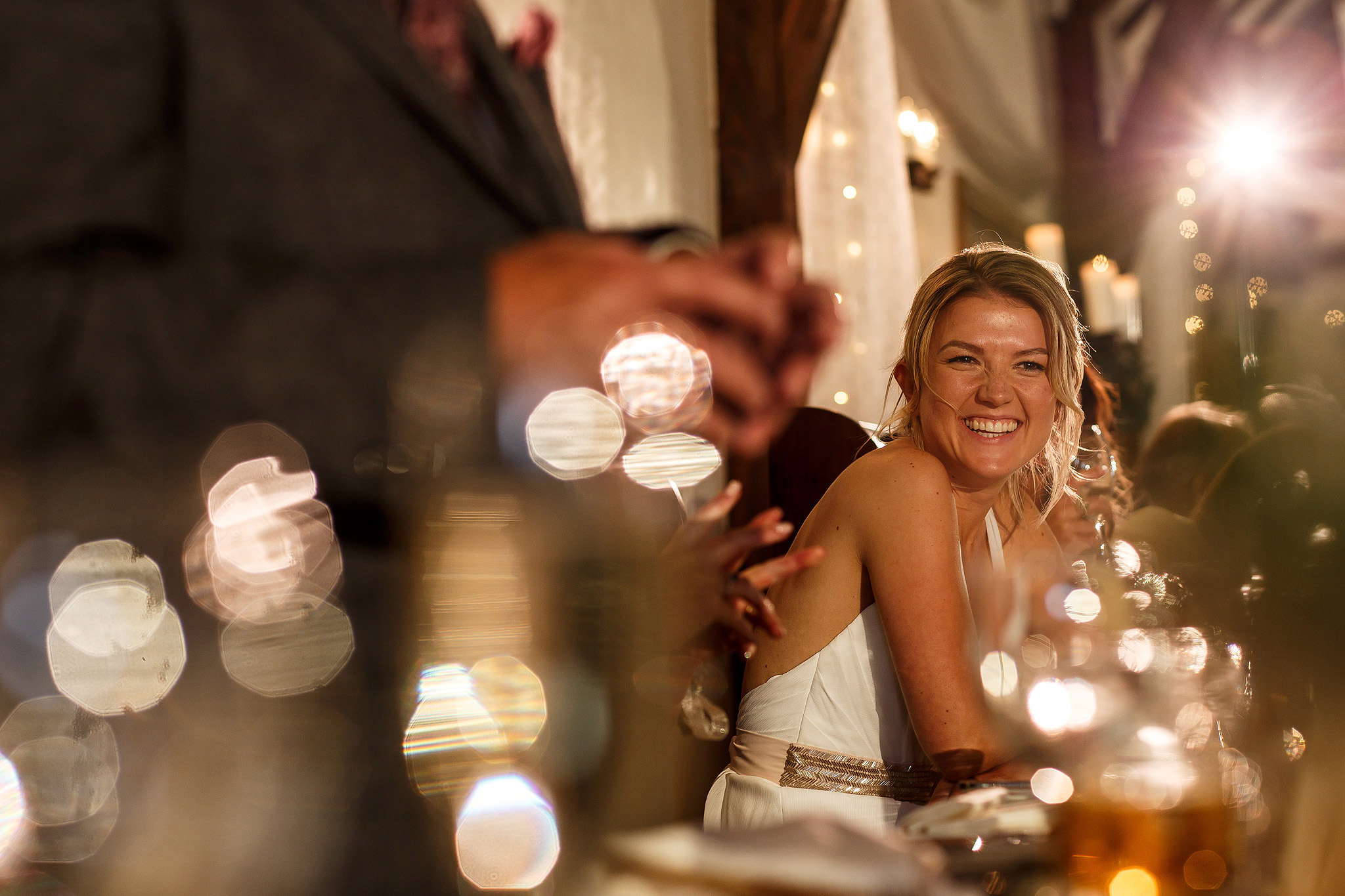 bride laughing during wedding speeches at the great hall at mains