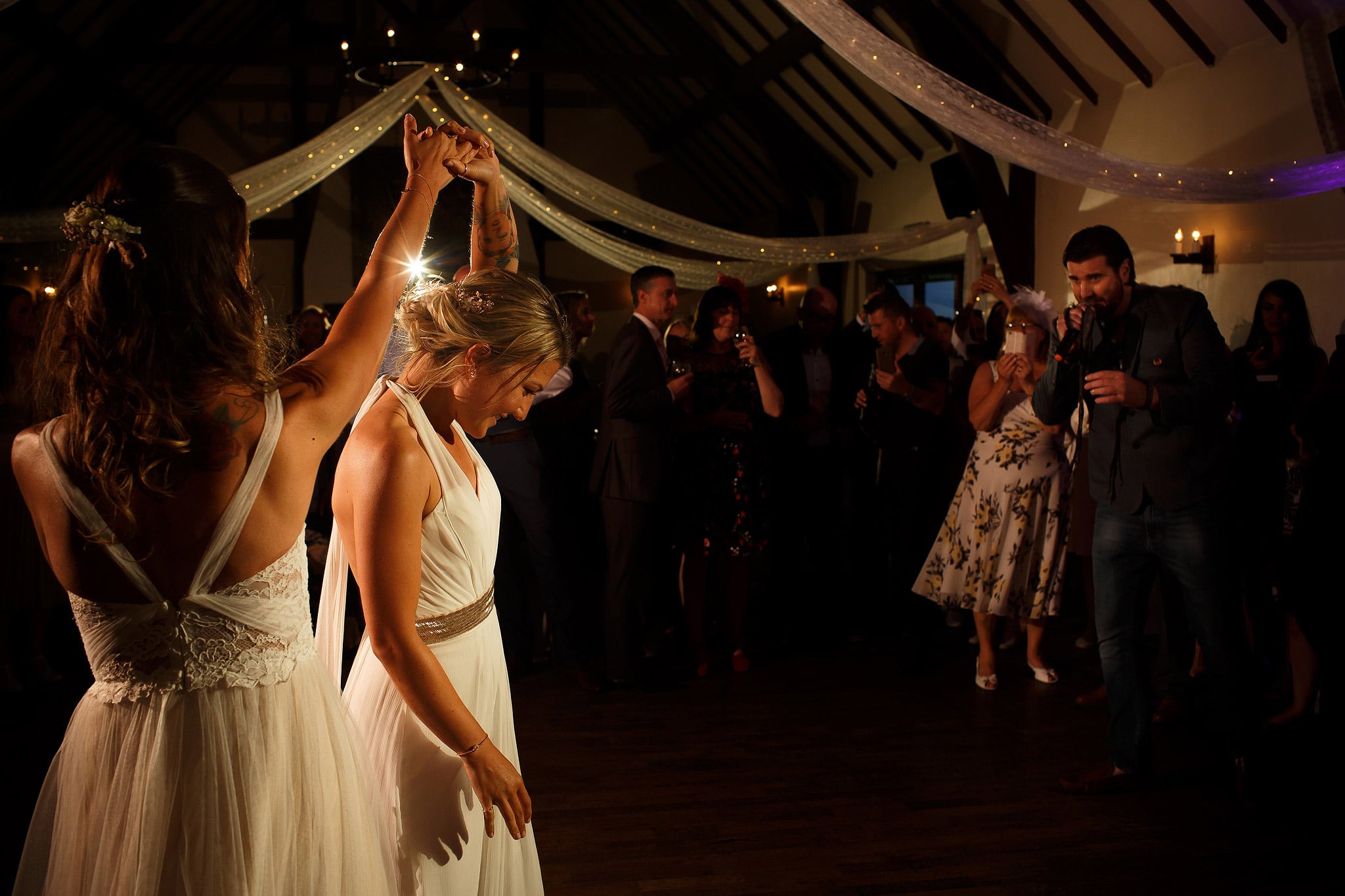 Brides twirling round the dance floor at great hall at mains wedding