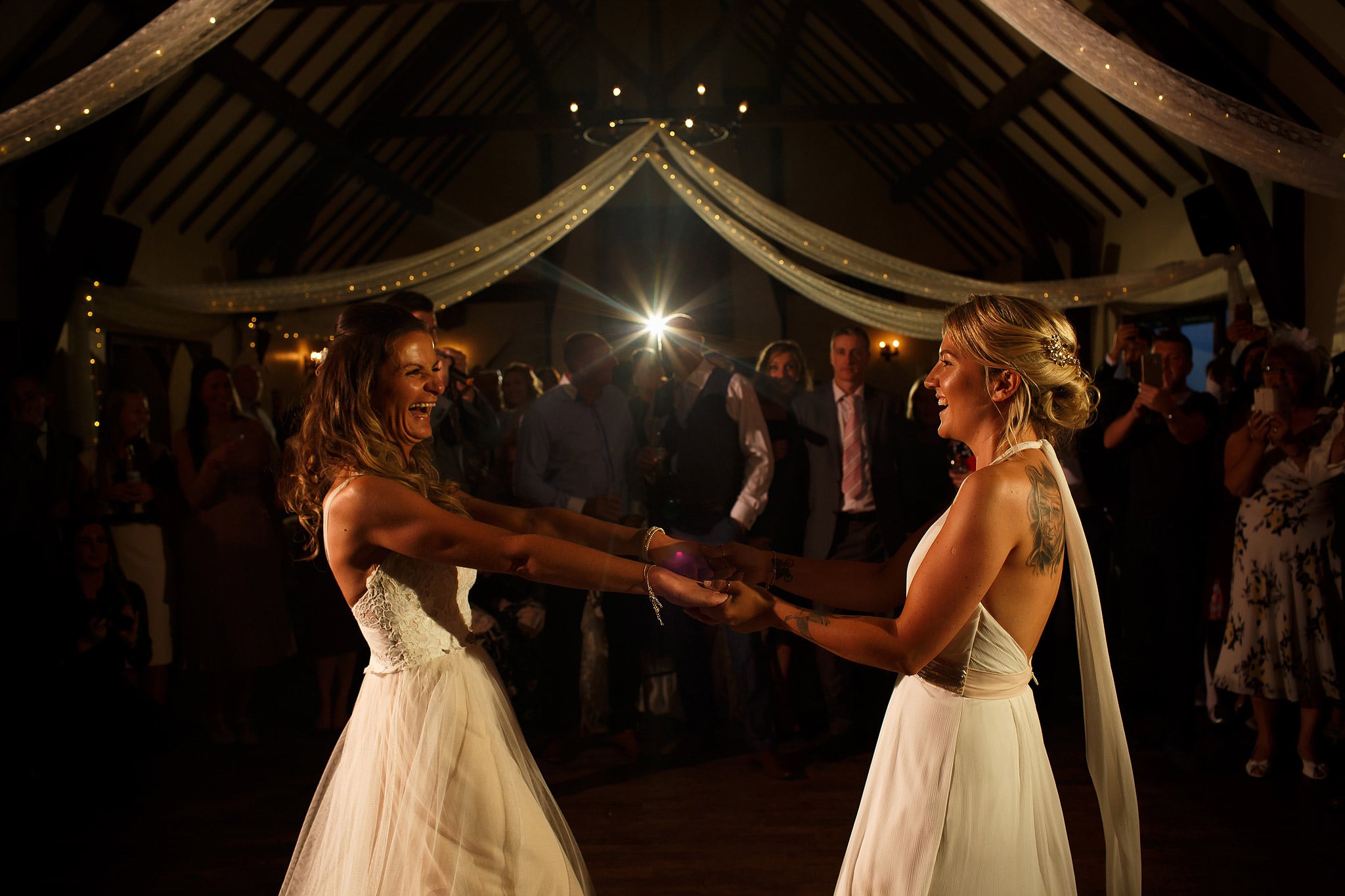 Brides twirling round the dance floor at great hall at mains wedding