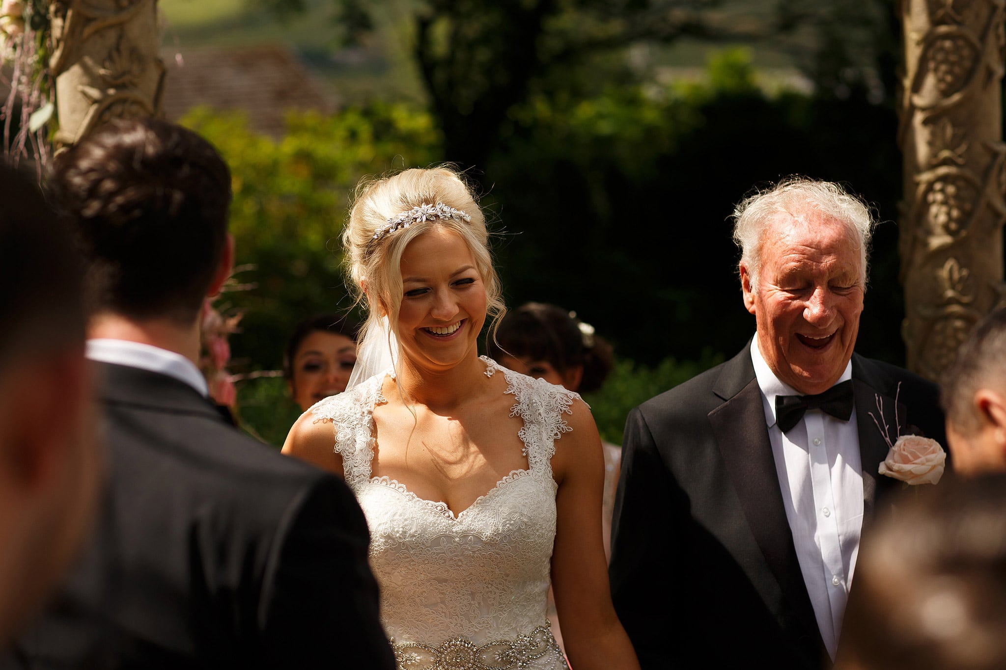 bride arriving at the top of the aisle under arch at saddleworth hotel