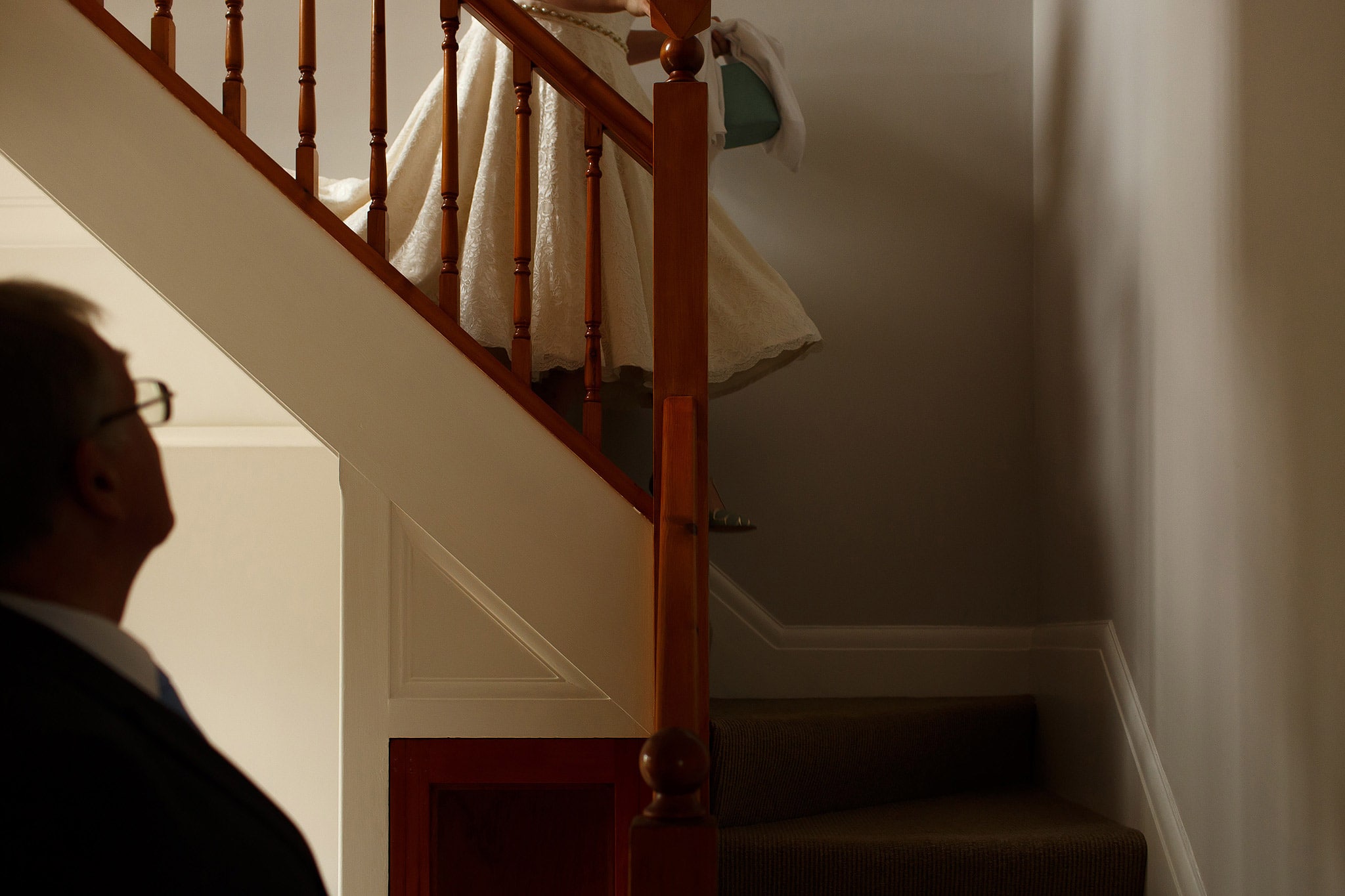 bride walking down the stairs to see her father