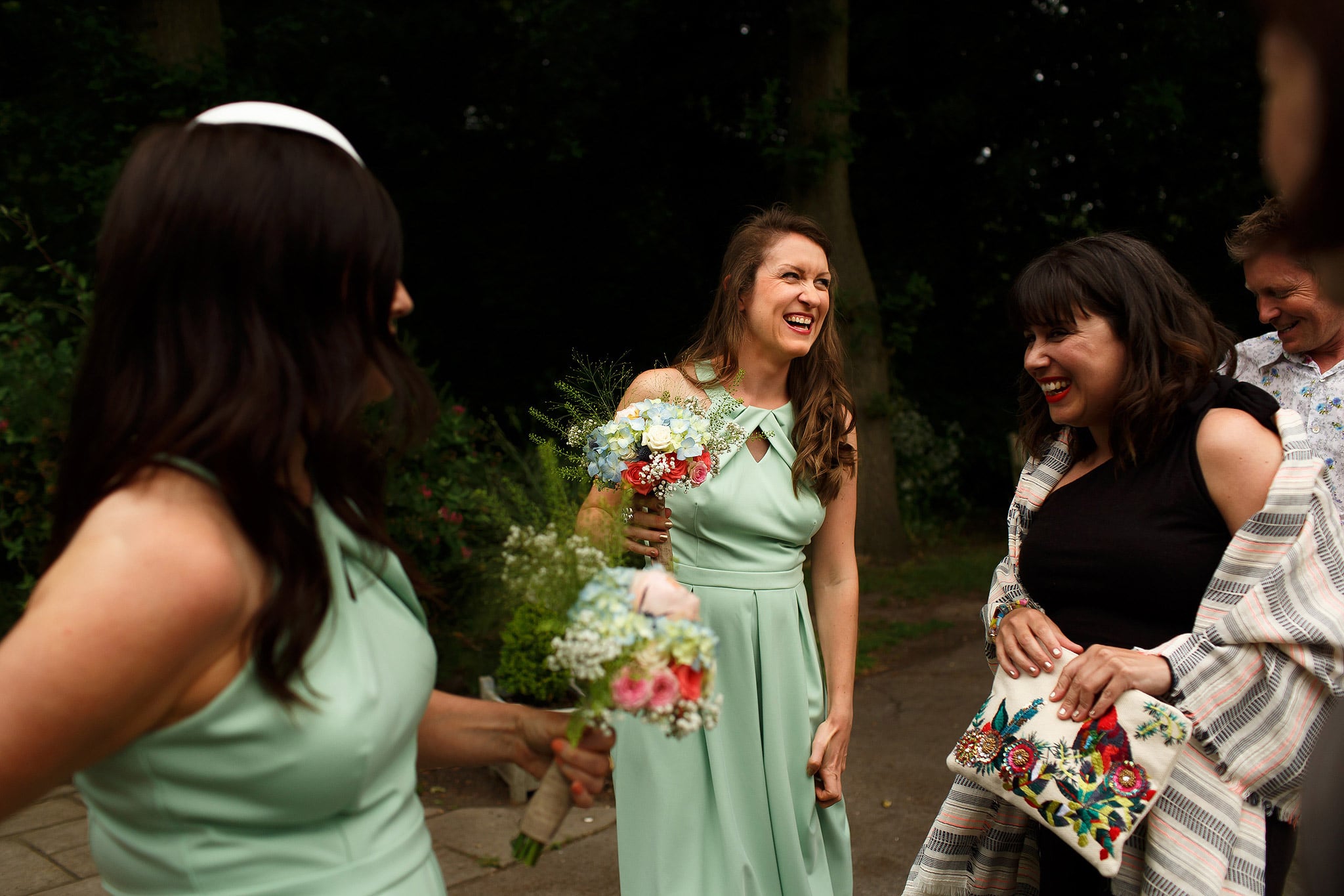 Bridesmaids wearing mint green dresses laughing