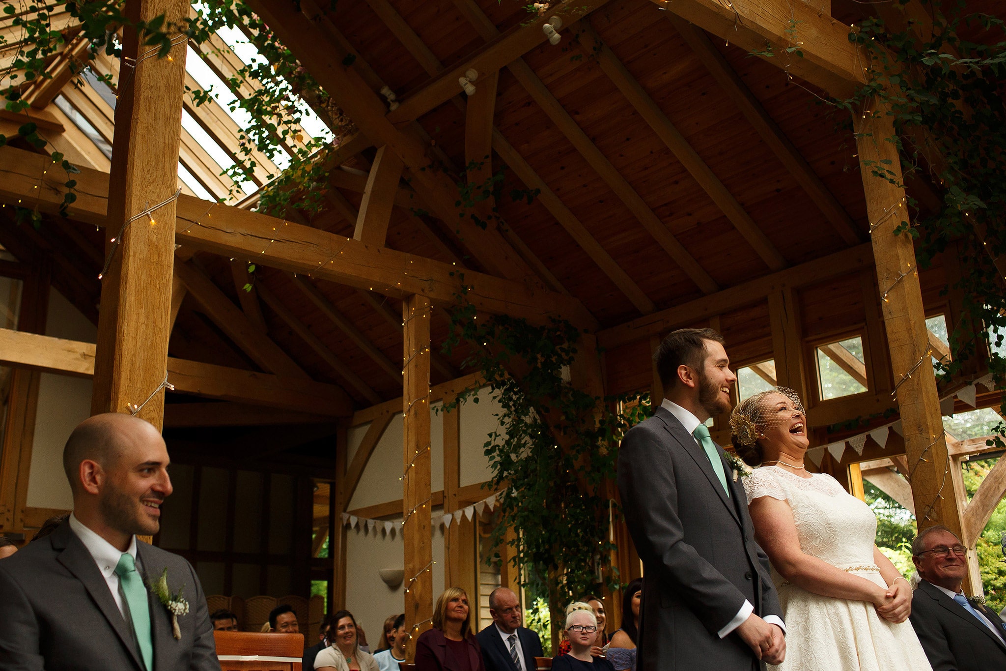 Bride and groom laughing during wedding ceremony at the Oak Tree at Peover