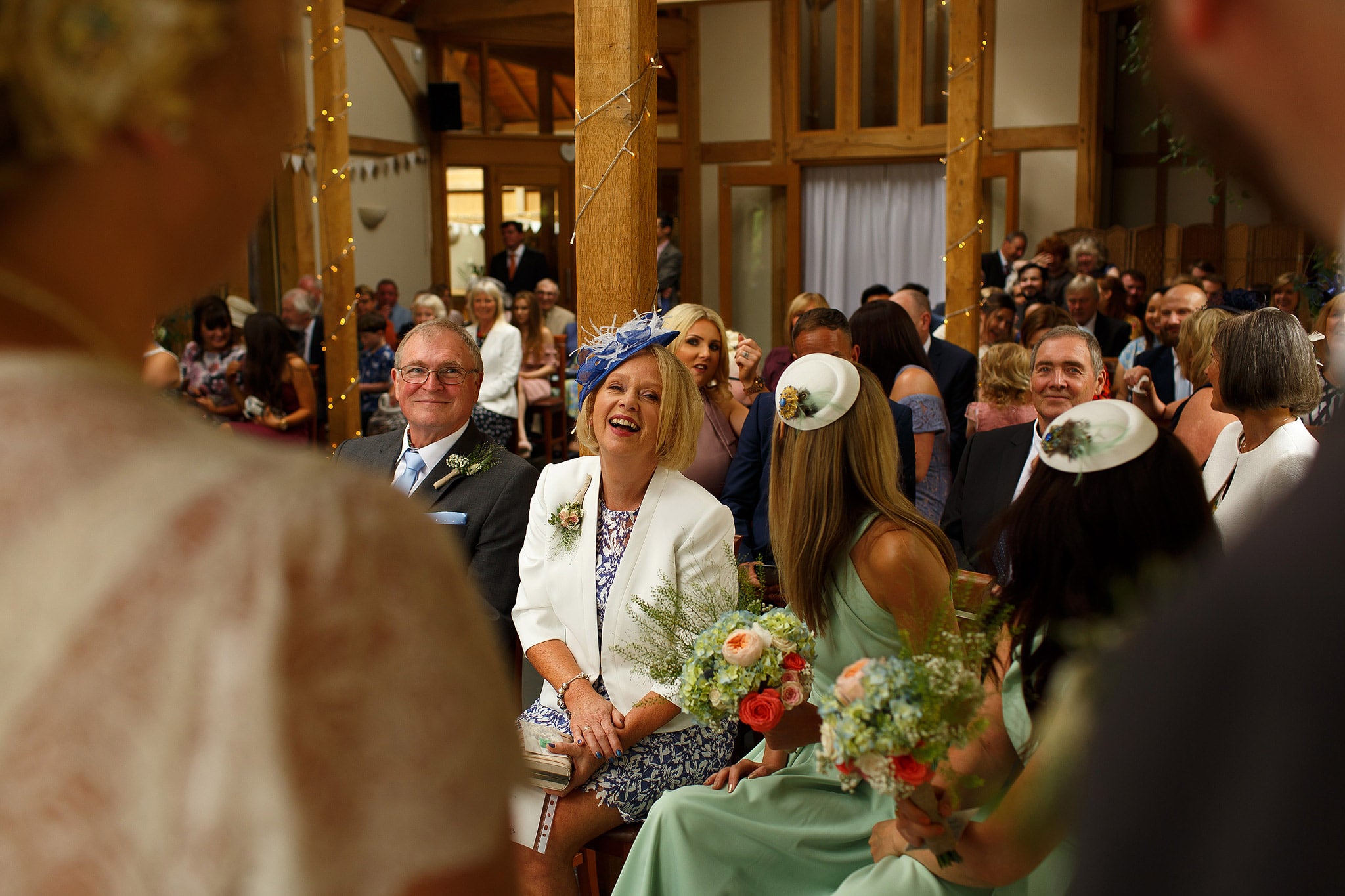 Wedding guests laughing during Oak Tree at Peover civil ceremony