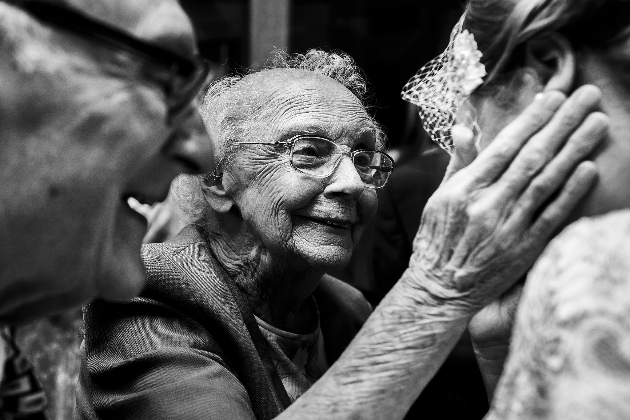 Award winning photograph of elderly relatives congratulating bride on wedding day 