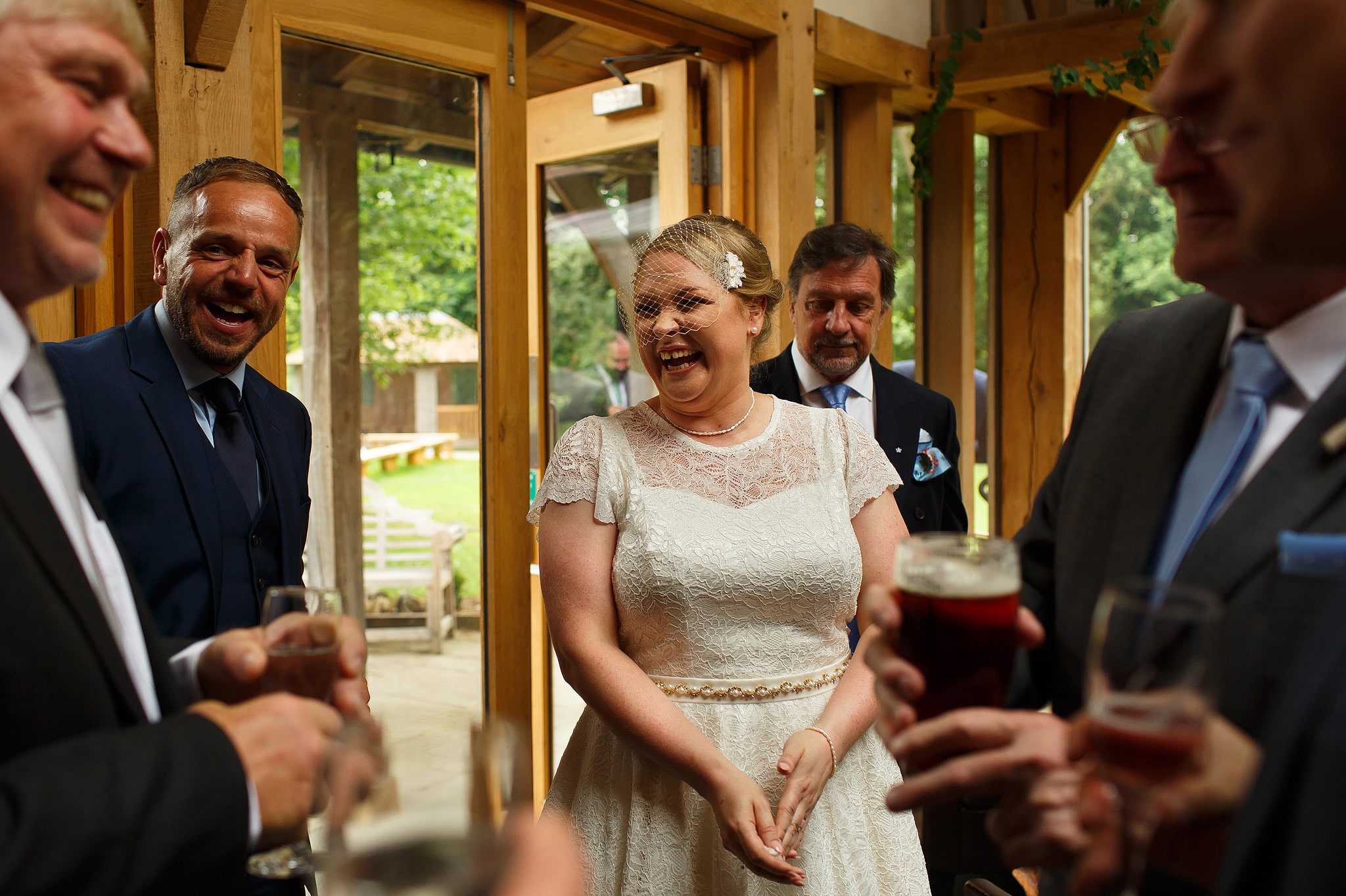Wedding guests laughing during Oak Tree at Peover civil ceremony