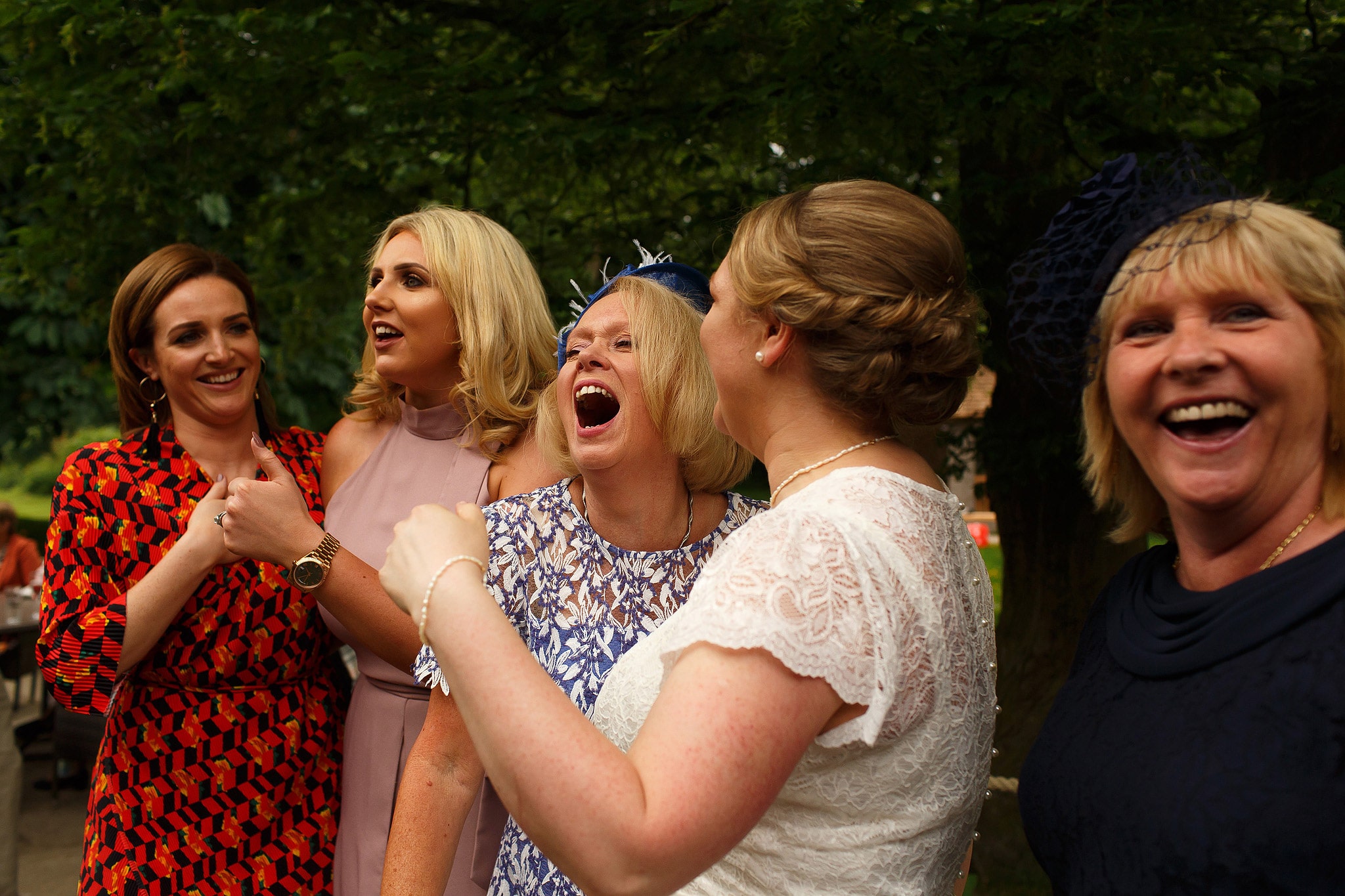 Wedding guests laughing during Oak Tree at Peover civil ceremony