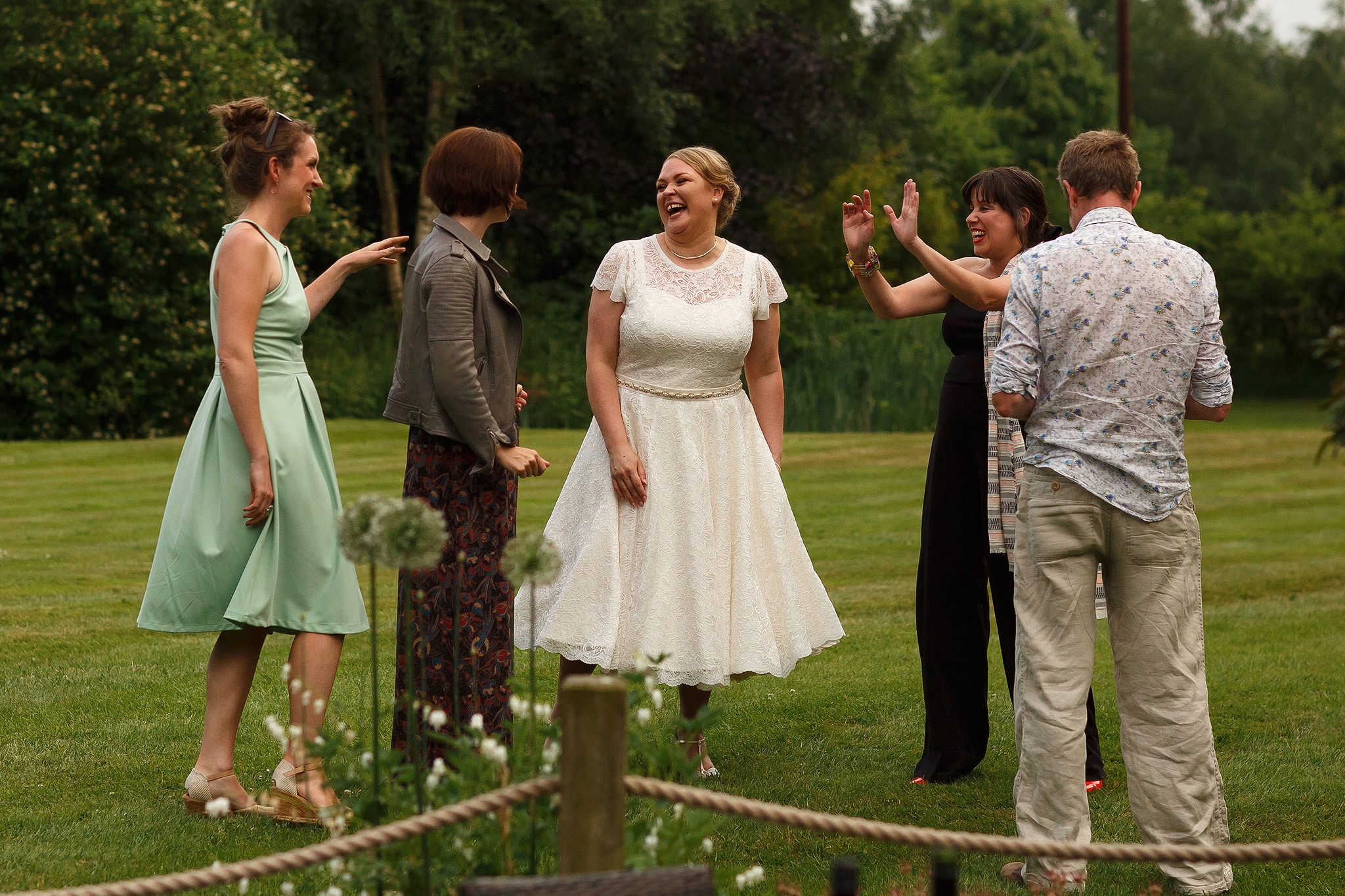 Wedding guests laughing during Oak Tree at Peover civil ceremony