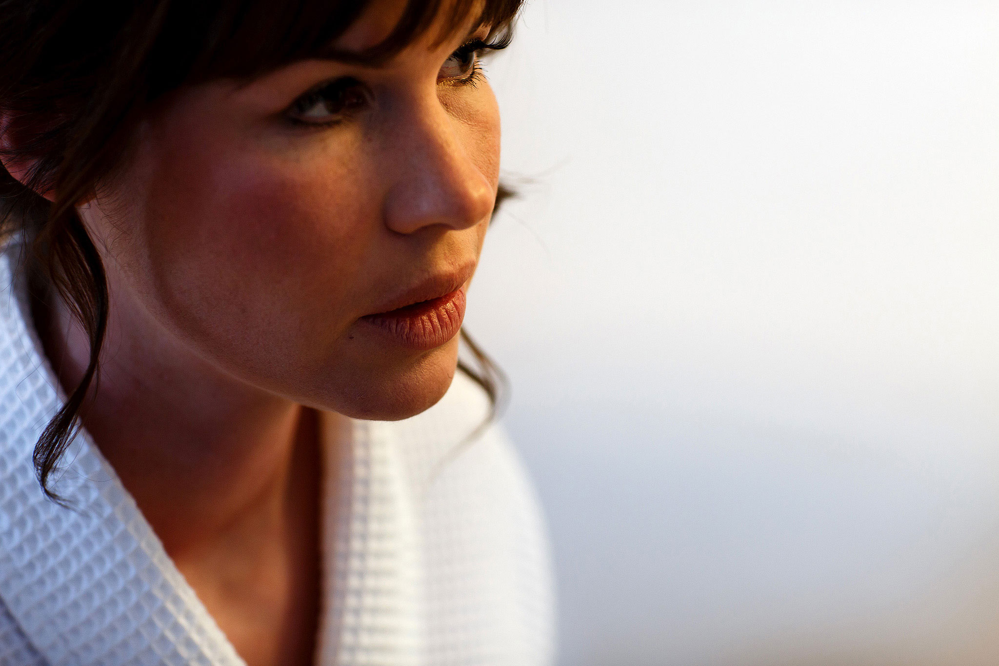 Close up portrait of bride with full fringe and brunette hair on the morning of her wedding day
