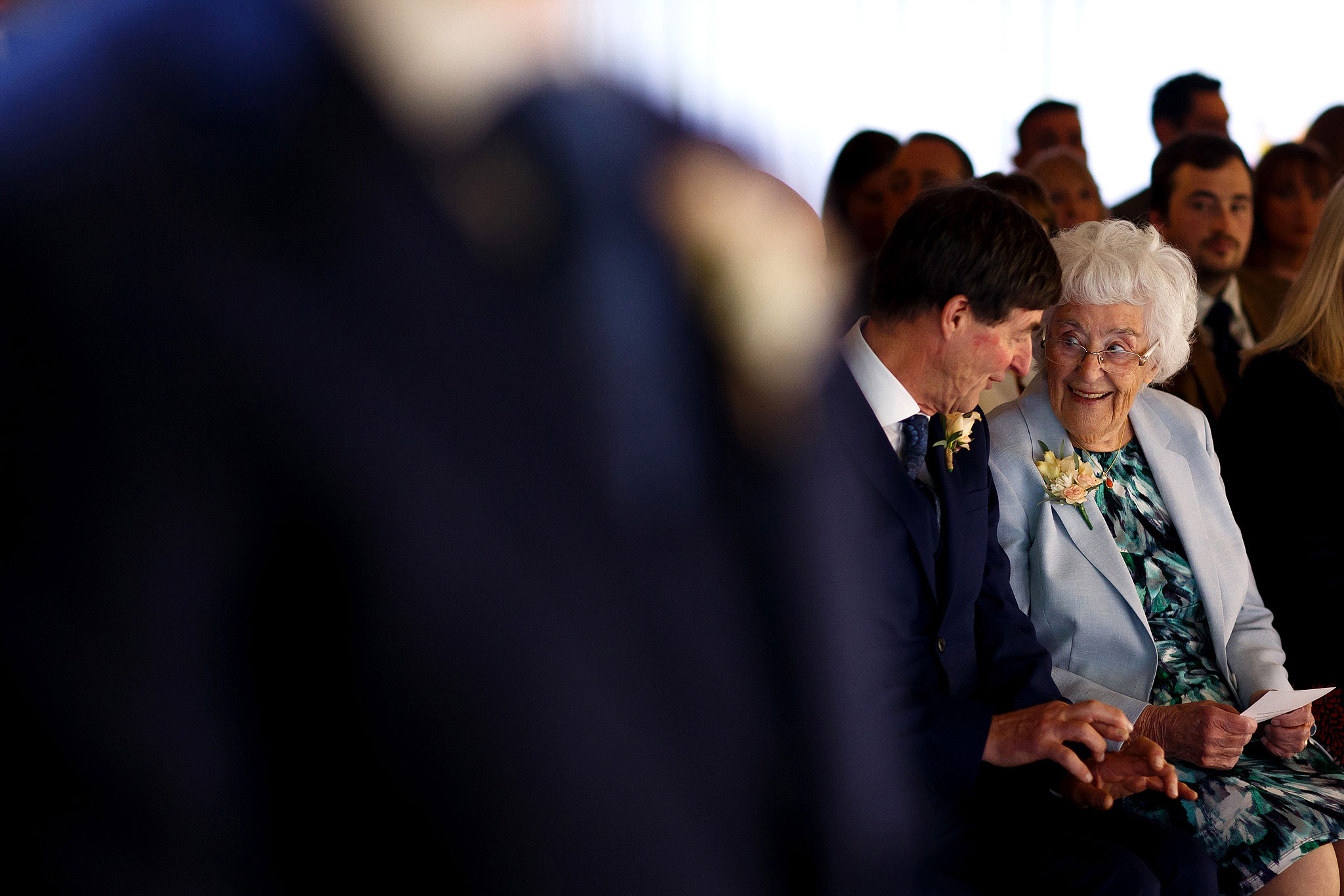 Wedding guests chatting before the ceremony at Rivington Hall Barn wedding