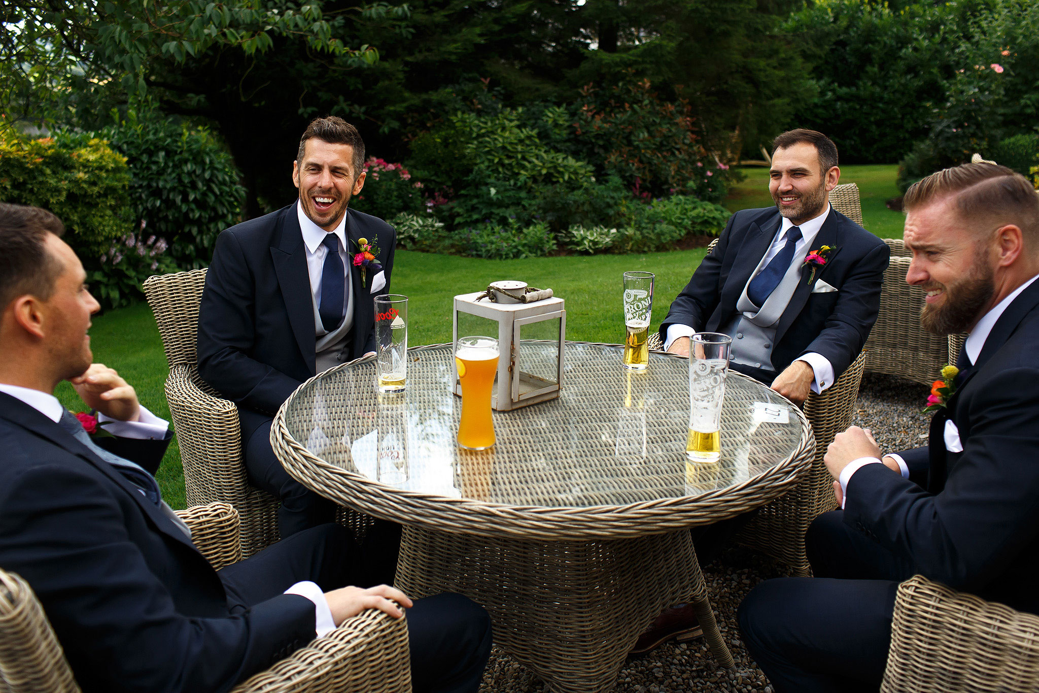 Groom and groomsmen drinking a beer in the garden at Shireburn Arms
