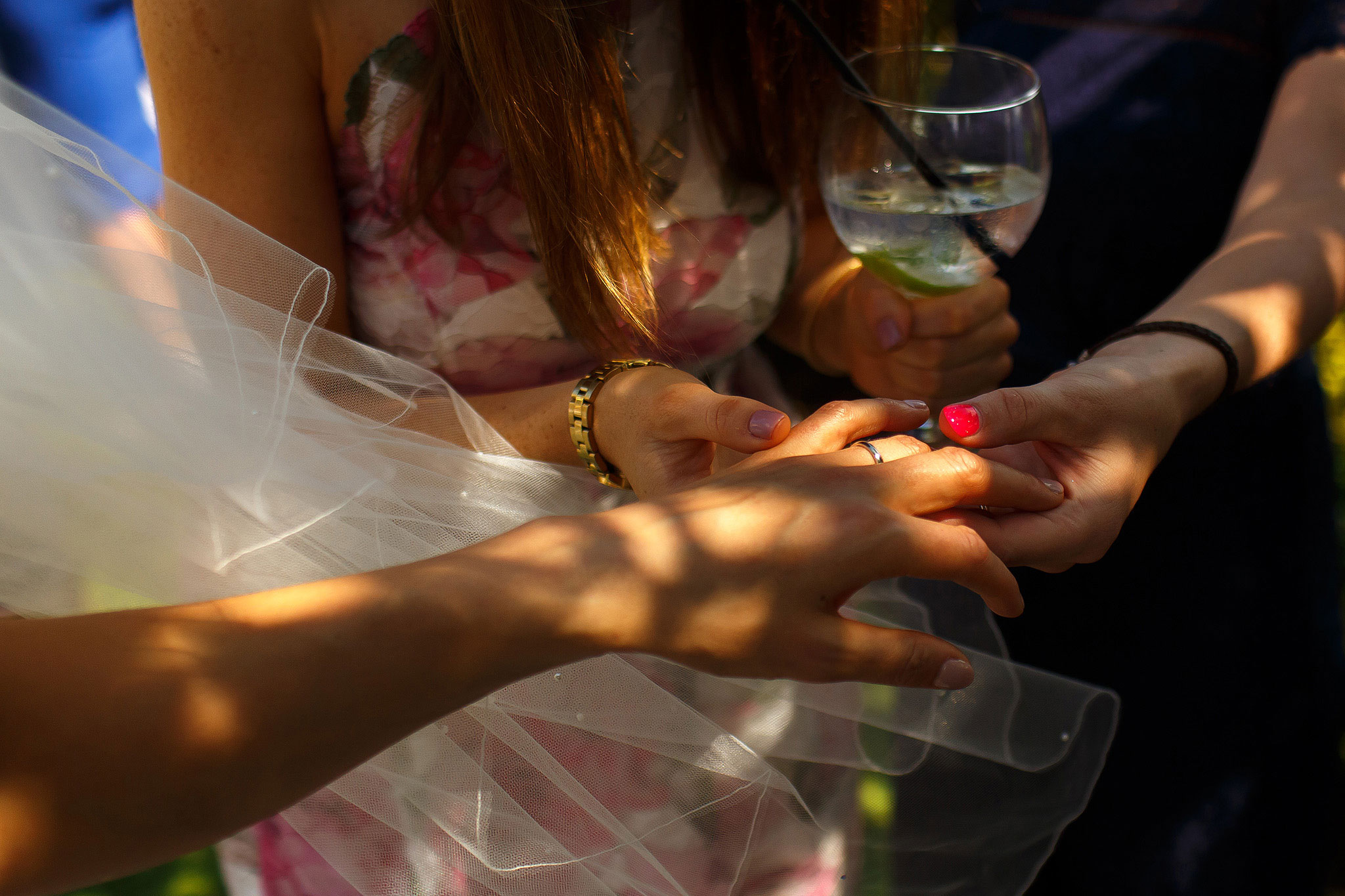 Bride showing off her wedding band to wedding guests