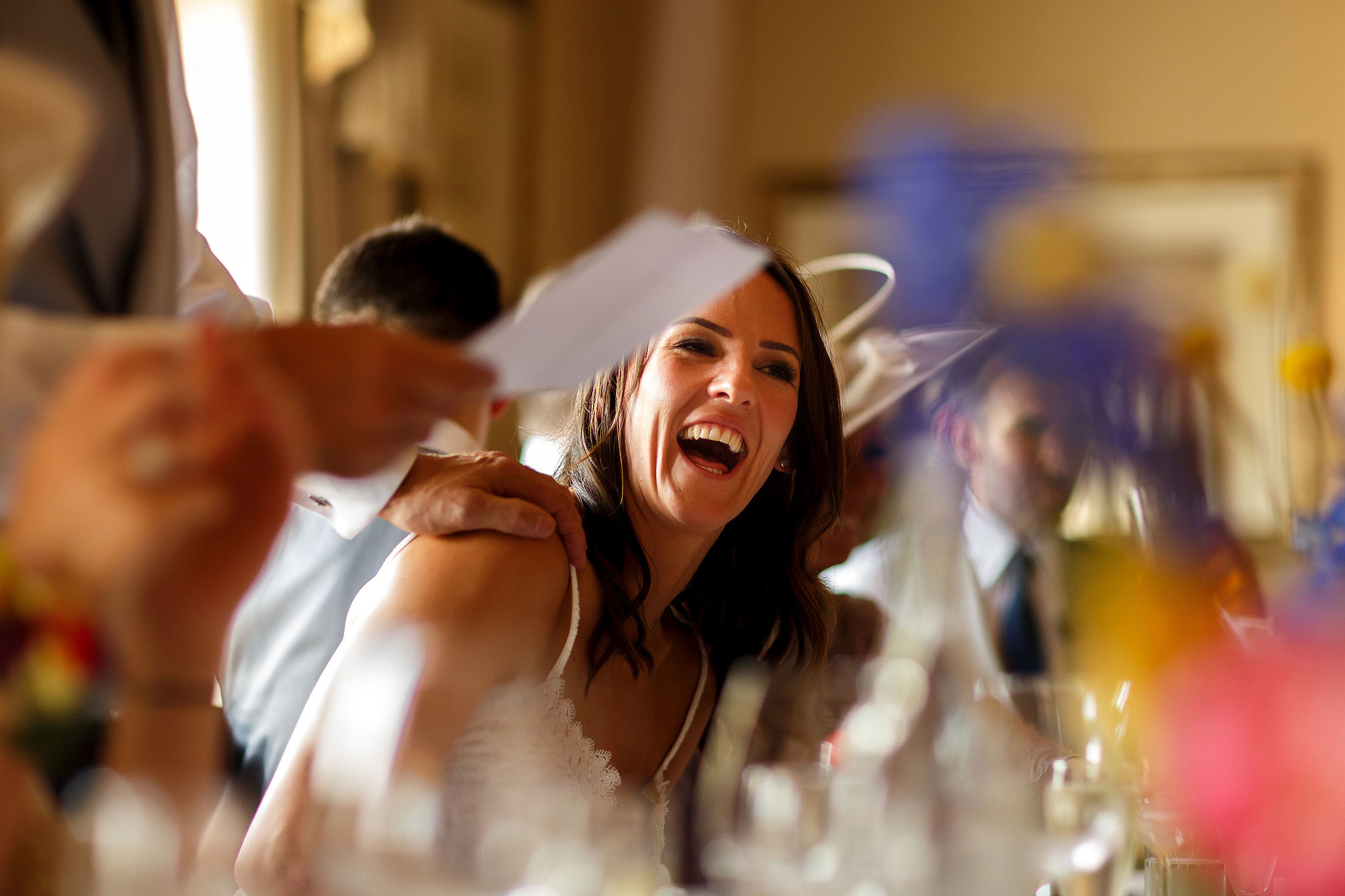 Bride laughing during speeches at Shireburn Arms
