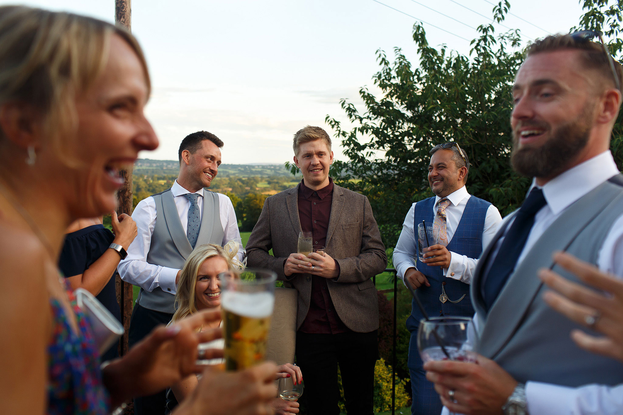 Wedding guests laughing during Shireburn Arms drinks reception