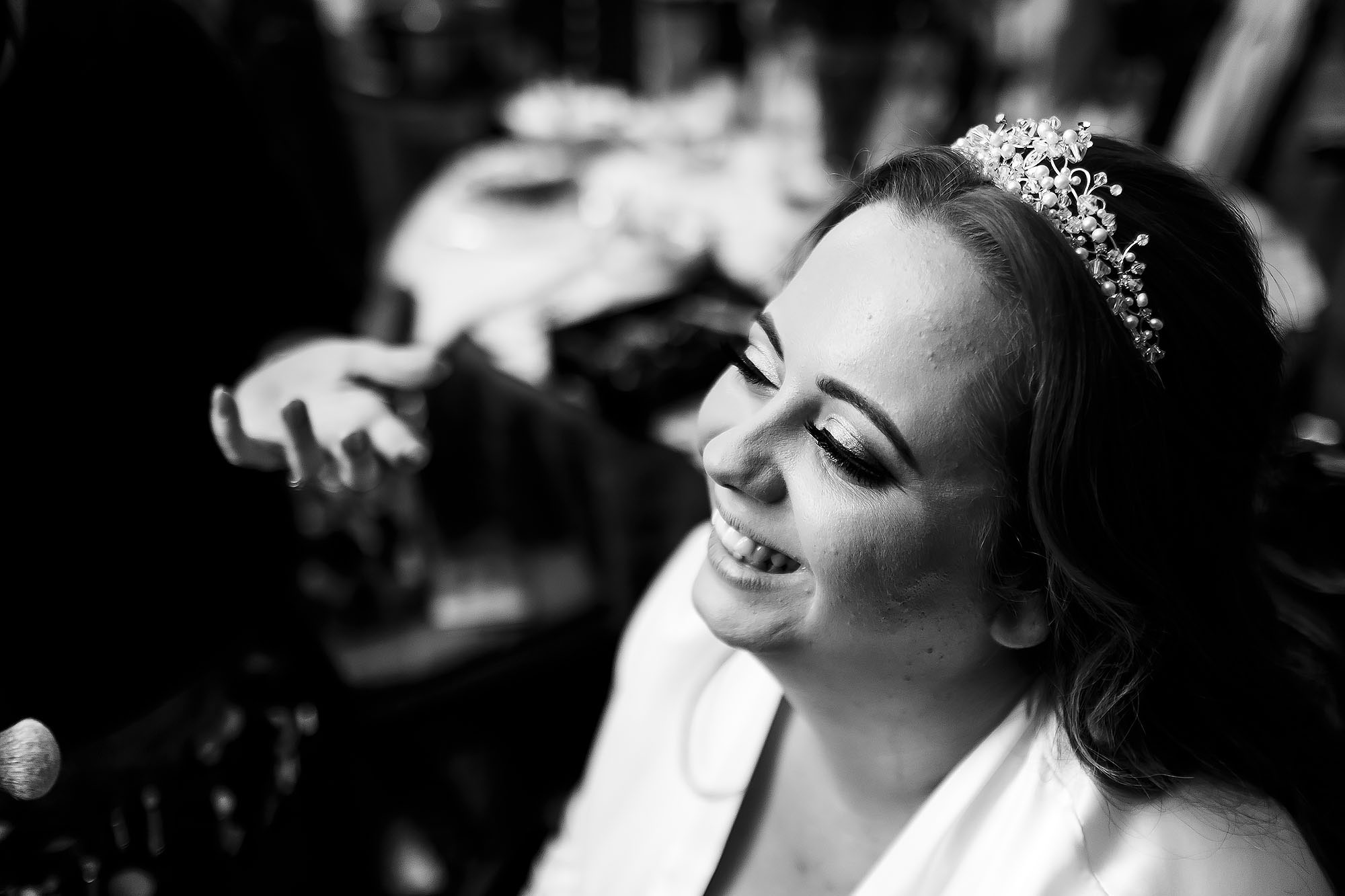 Bride wearing long eyelashes and hairpiece having make up applied on wedding morning | Wellbeing Farm wedding photographs by Toni Darcy Photography