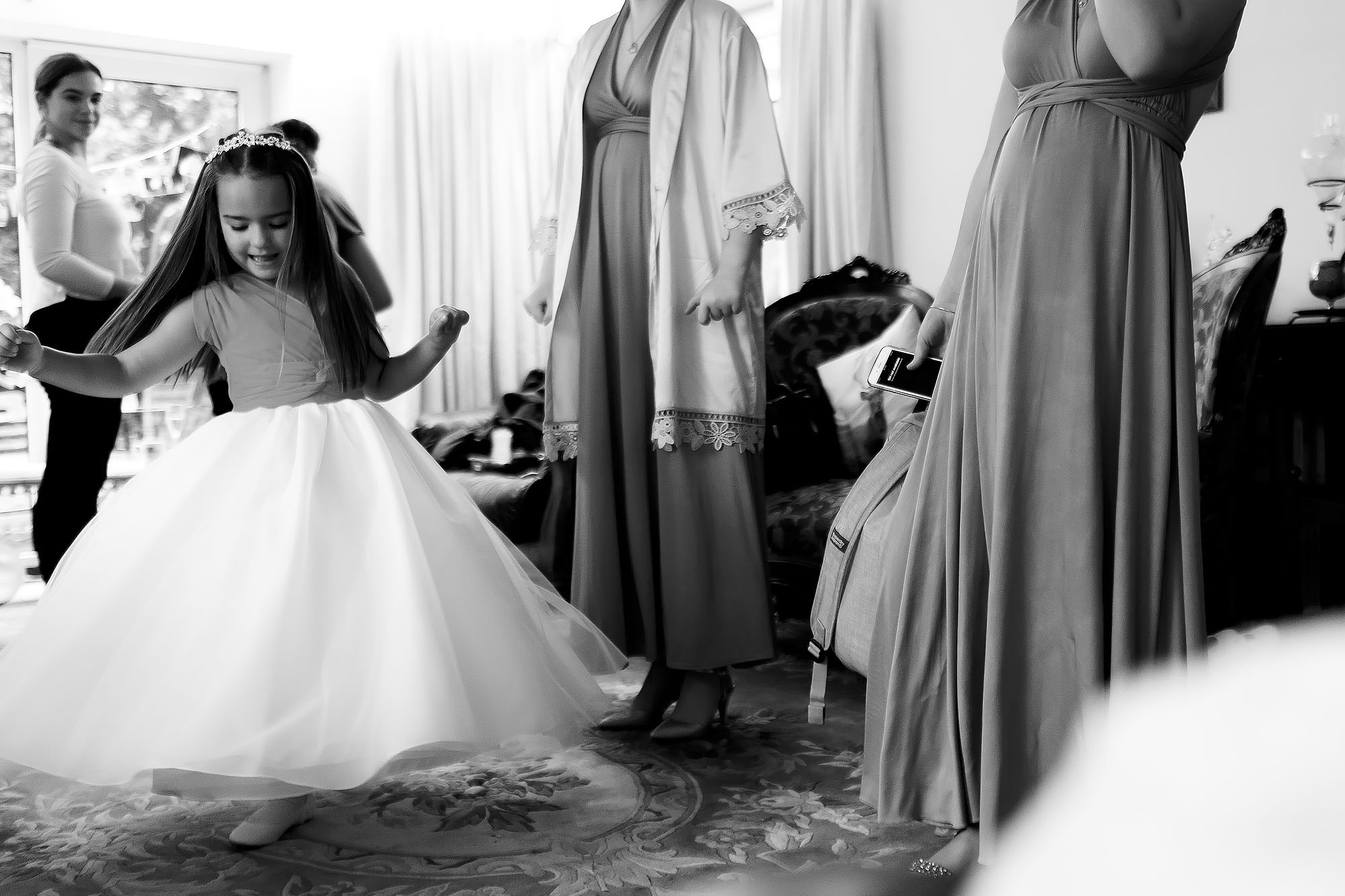 Flower girl dancing and twirling as skirt flares during wedding morning | Wellbeing Farm wedding photographs by Toni Darcy Photography