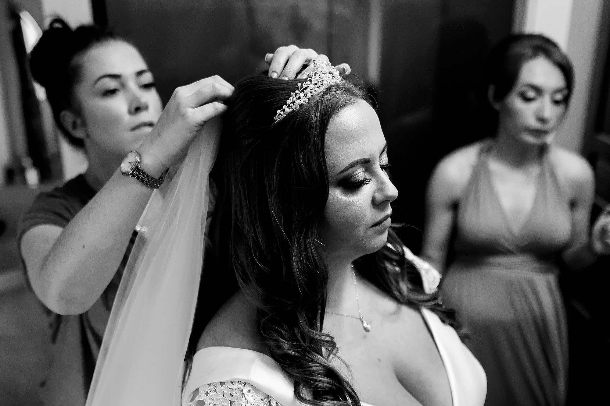 Bride looking down with long eyelashes as the veil is applied to her hair | Wellbeing Farm wedding photographs by Toni Darcy Photography