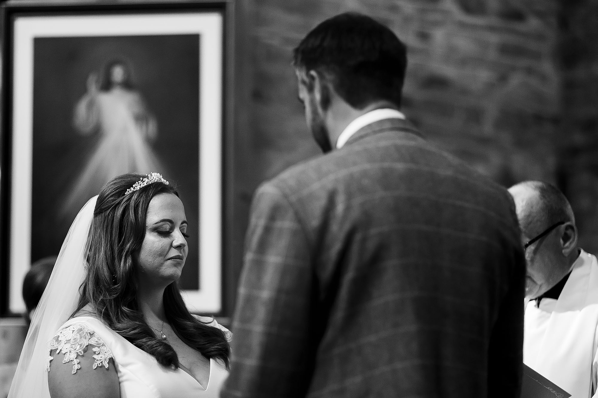 Bride closing her eyes taking in the moment as she says wedding vows | Wellbeing Farm wedding photographs by Toni Darcy Photography