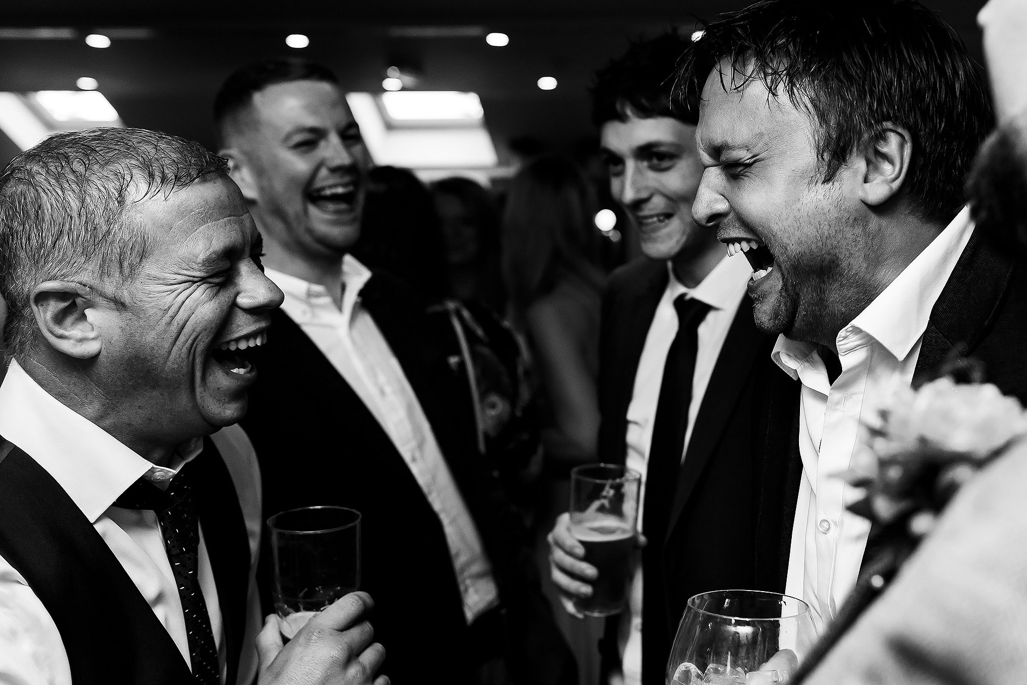 Wedding guests laughing enjoying the drinks reception at Wellbeing Farm | Wellbeing Farm wedding photographs by Toni Darcy Photography