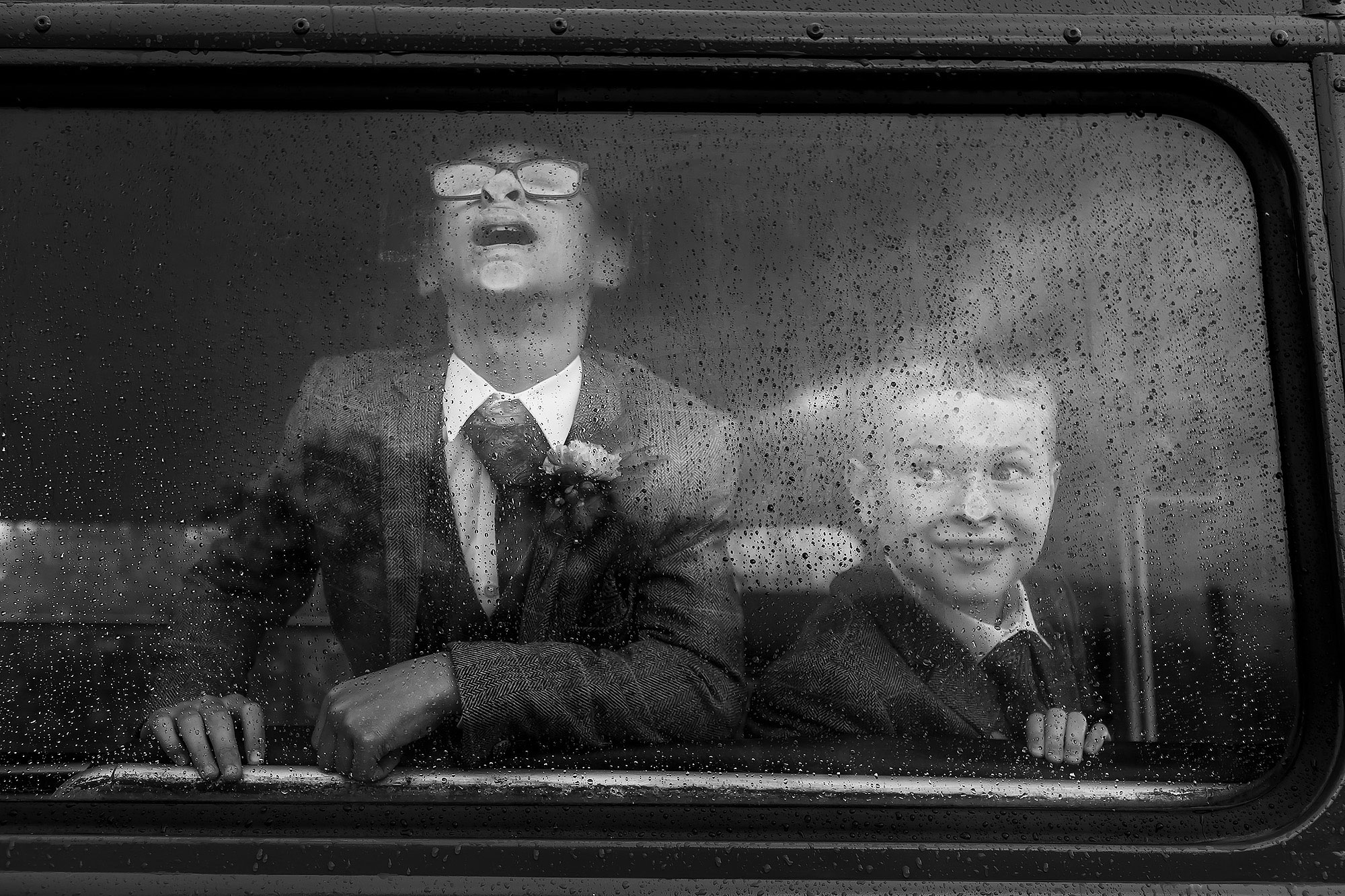 Page Boys pulling faces against the wedding bus window | Wellbeing Farm wedding photographs by Toni Darcy Photography
