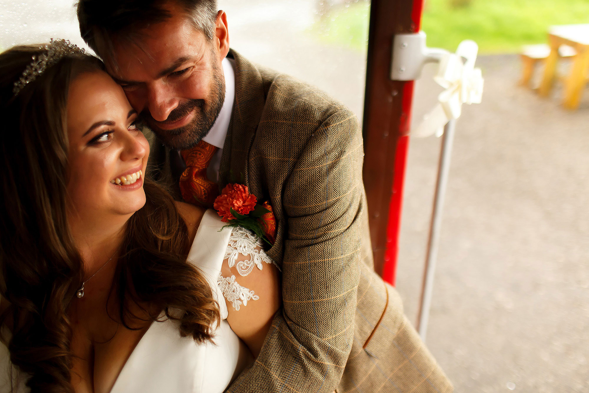Bride and groom hugging on the steps of the wedding bus | Wellbeing Farm wedding photographs by Toni Darcy Photography