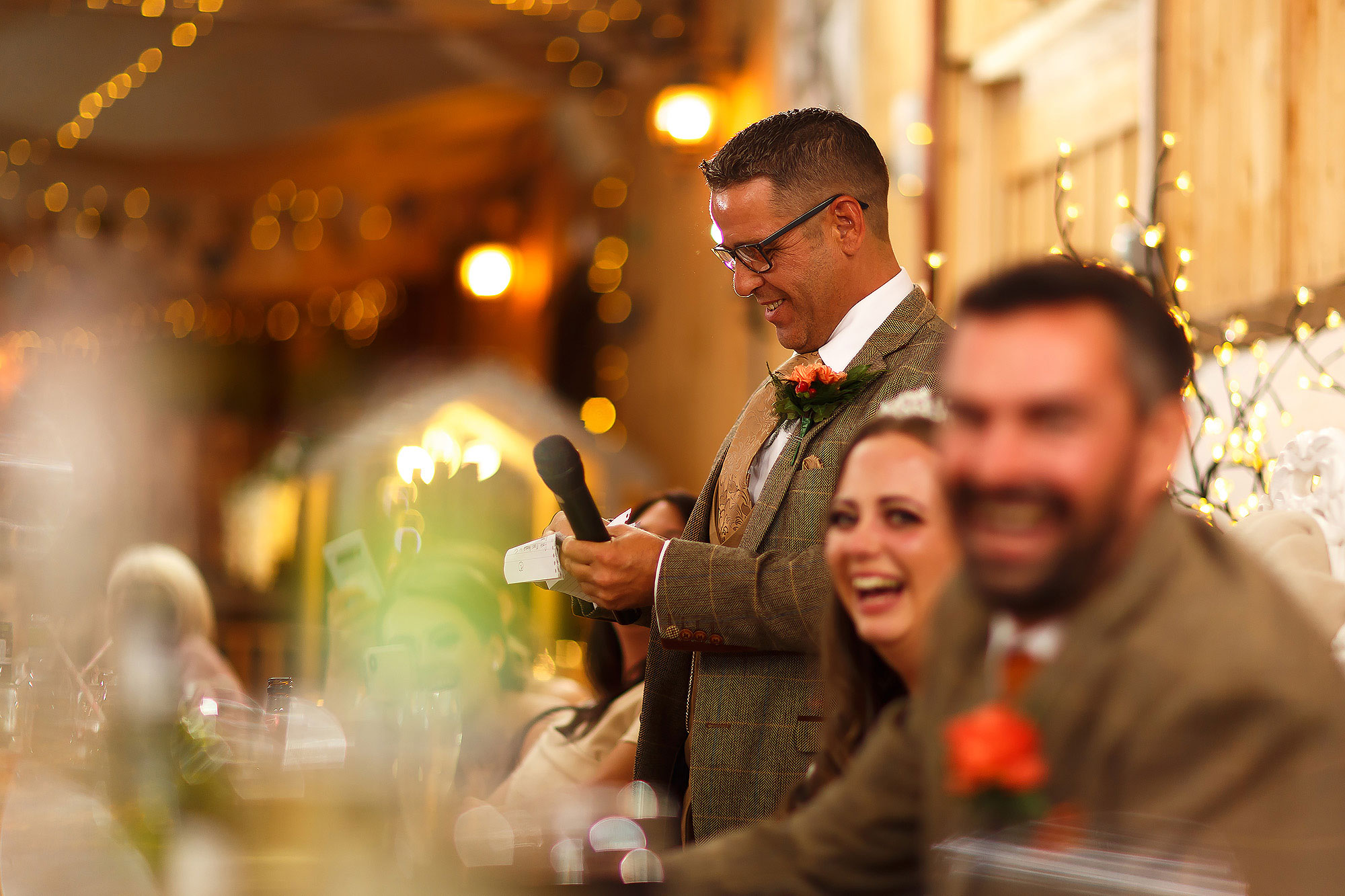 Bride and Groom laughing at the Father of the Bride speech inside the Wellbeing Farm | Wellbeing Farm wedding photographs by Toni Darcy Photography
