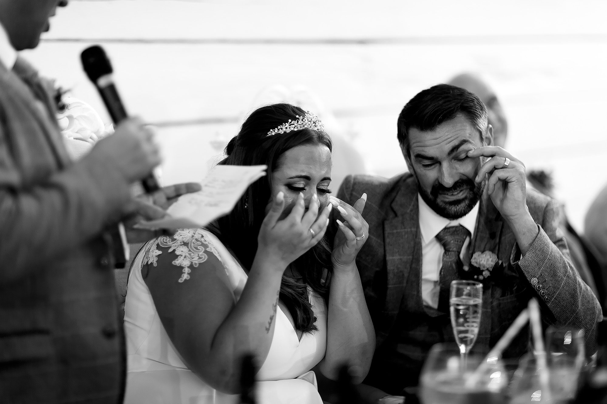 Bride and groom crying laughing during the speeches | Wellbeing Farm wedding photographs by Toni Darcy Photography