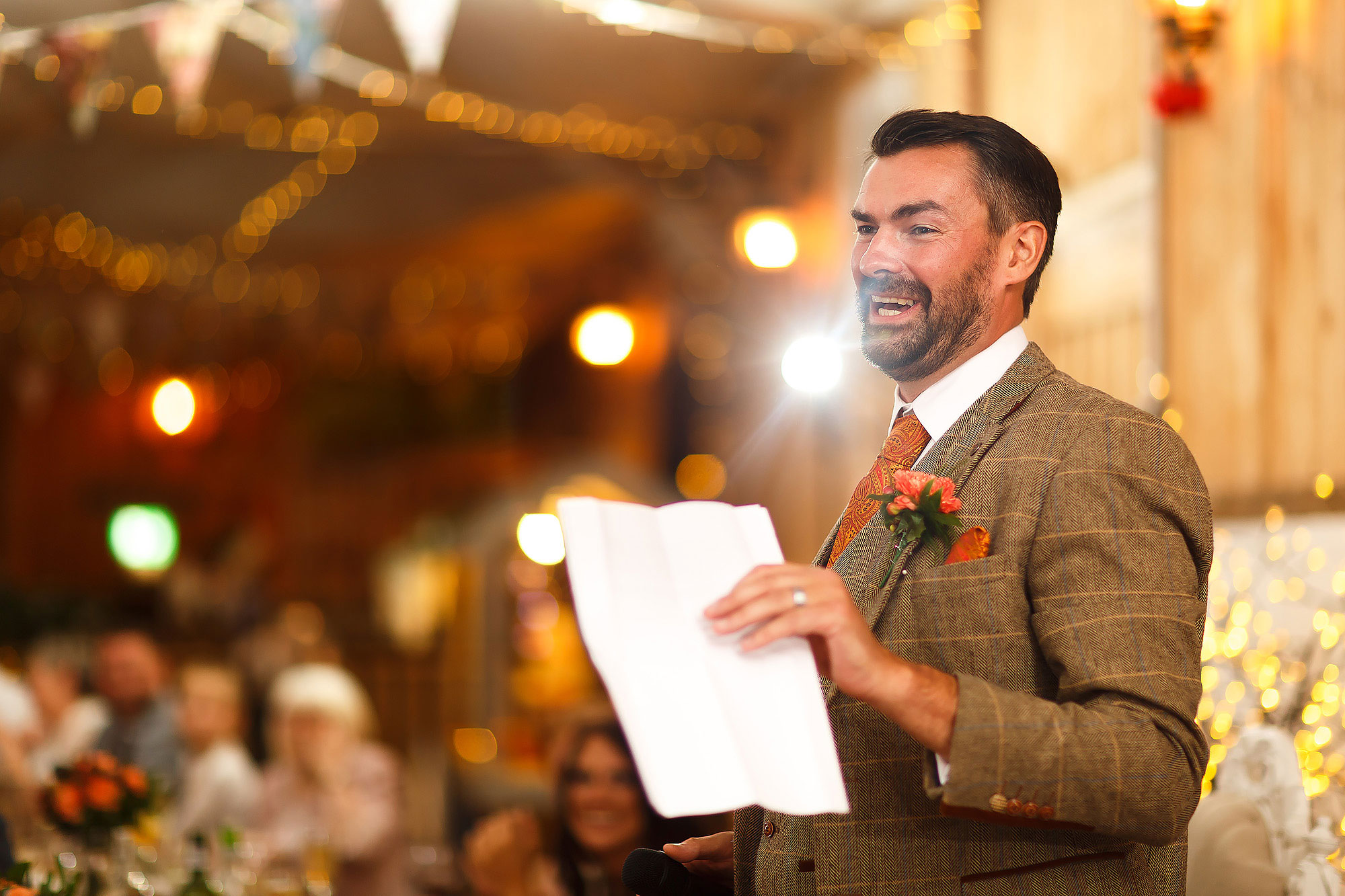 Groom wearing tweed suit with orange paisley tie and pocket square | Wellbeing Farm wedding photographs by Toni Darcy Photography