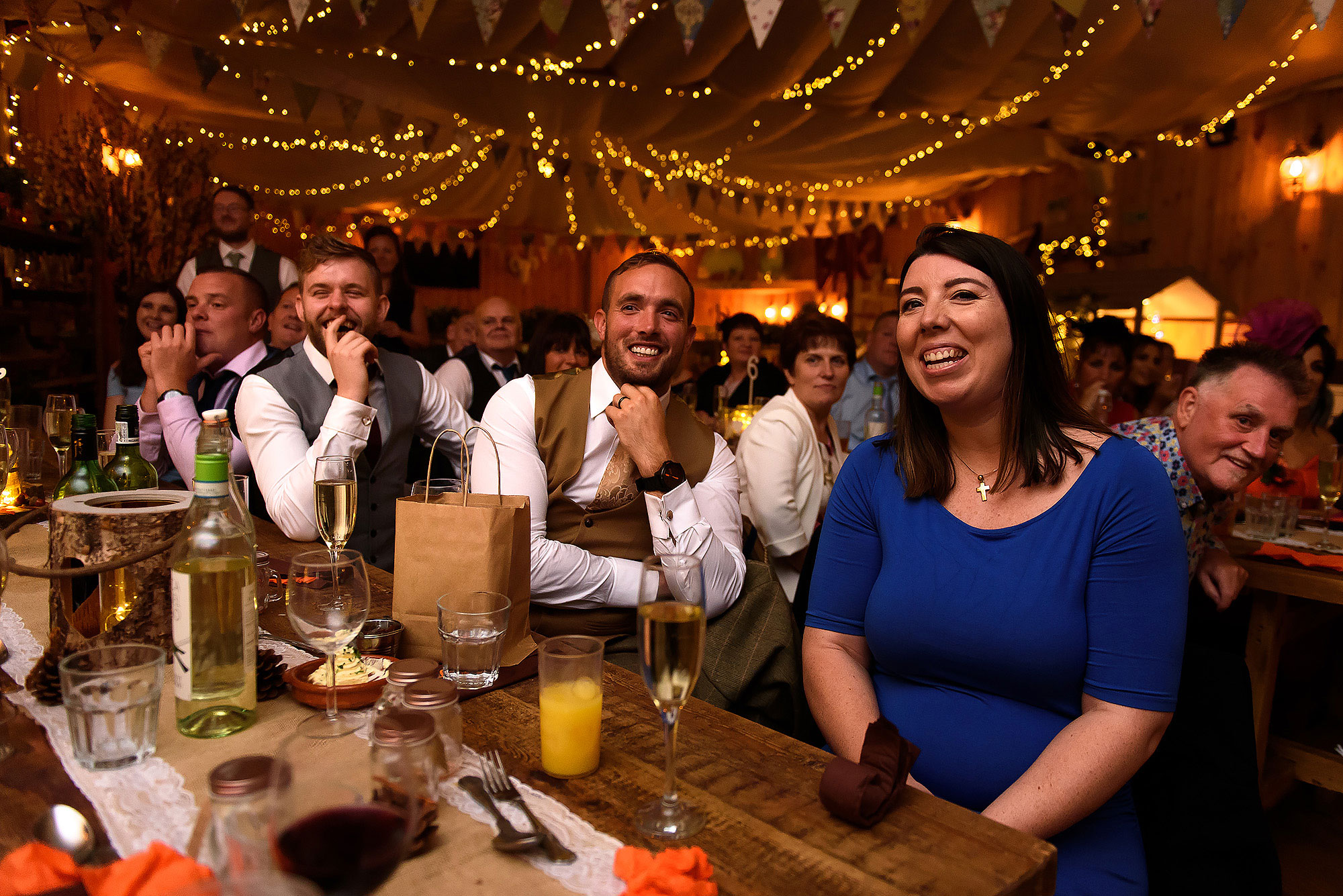 Wedding guests laughing during wedding speeches | Wellbeing Farm wedding photographs by Toni Darcy Photography