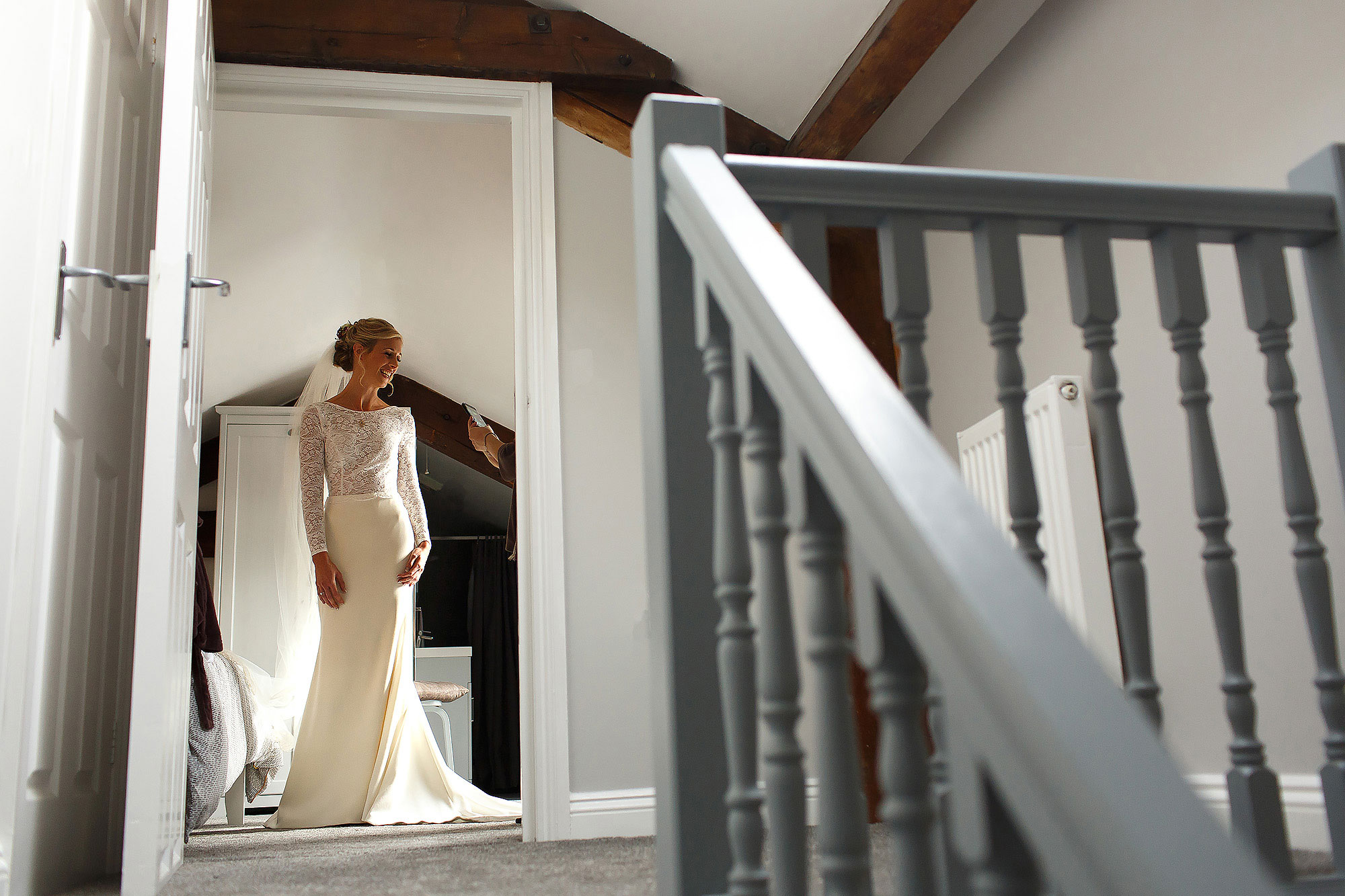 Bride standing in her wedding dress ready to leave for the venue - The Out Barn at Clough Bottom Wedding Photography
