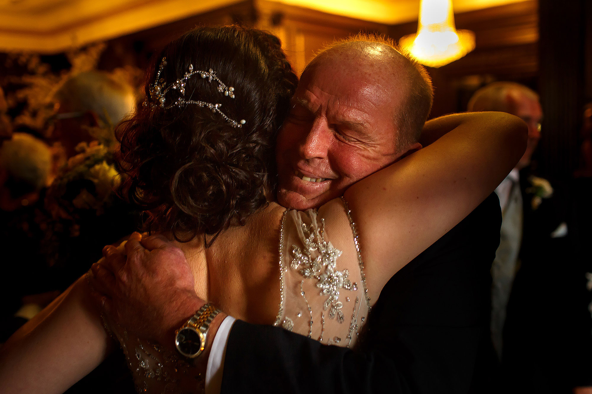 Bride and groom greeting and hugging wedding guests after the wedding ceremony | Eaves Hall wedding photography by Toni Darcy