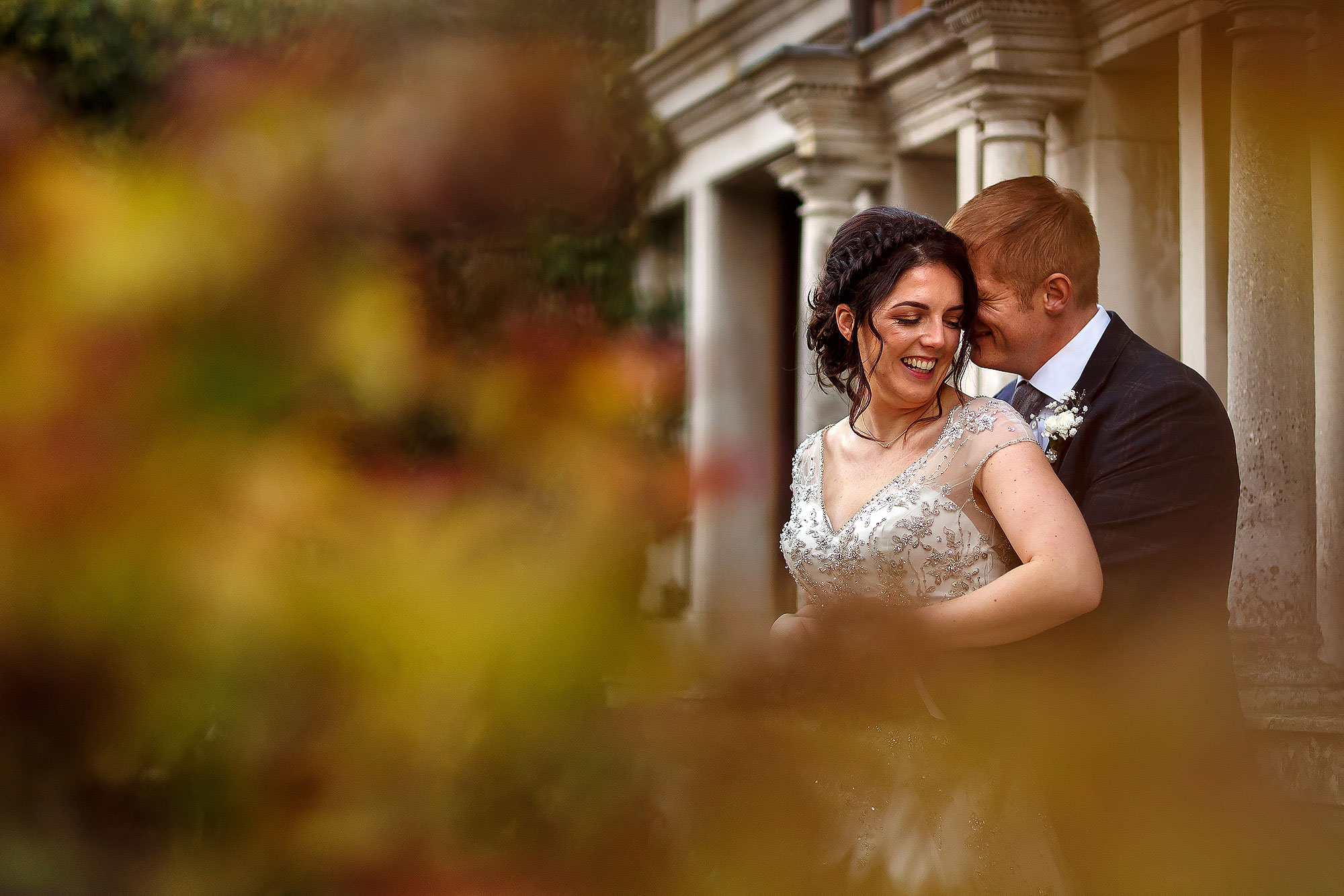 Bride and groom laughing in each others arms in the gardens | Eaves Hall wedding photography by Toni Darcy